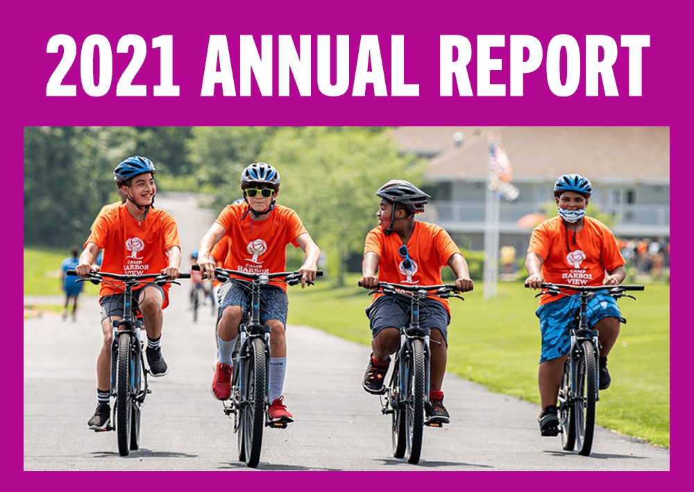 2021 Annual Report - photo of 4 boys wearing orange Camp Harbor View t-shirts, riding bicycles on Long Island, Boston