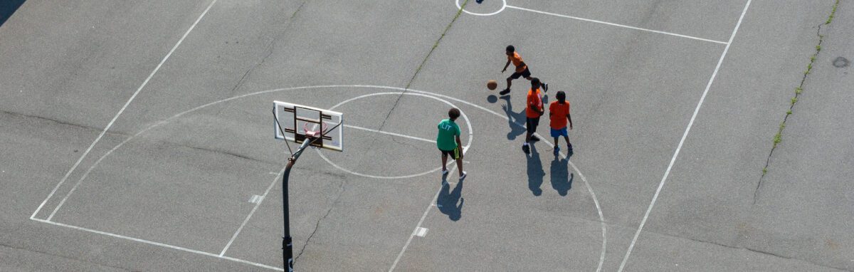 Leader in Training and campers on basketball court from above