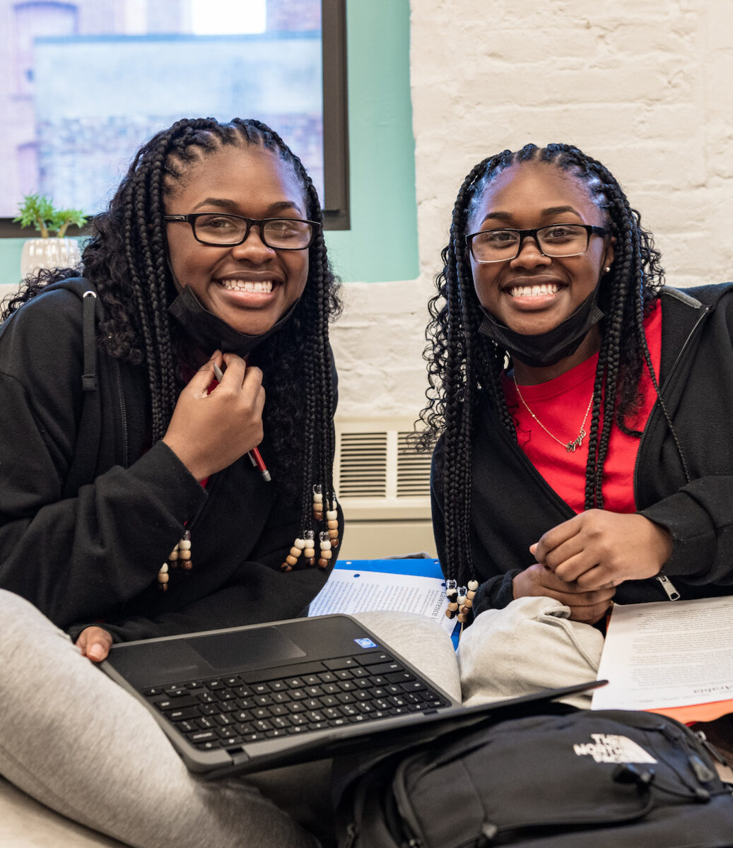 Twin teen girls smiling at the camera in Leadership Academy