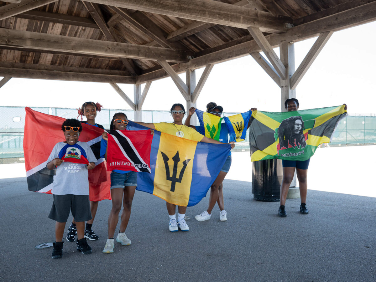 Campers holding up international flags
