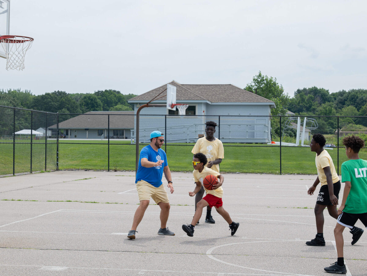 Josh and campers play basketball