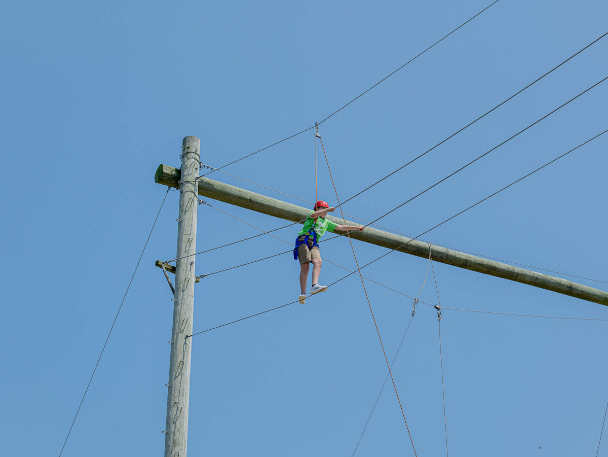 Camper on high ropes course
