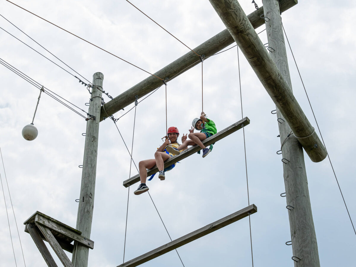 Campers smiling on ropes course
