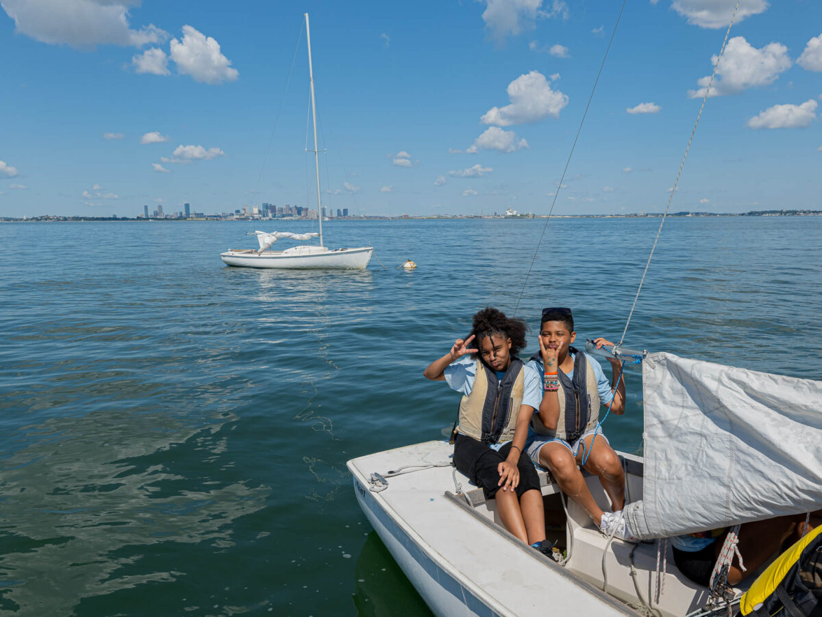 Campers smile on sailboat