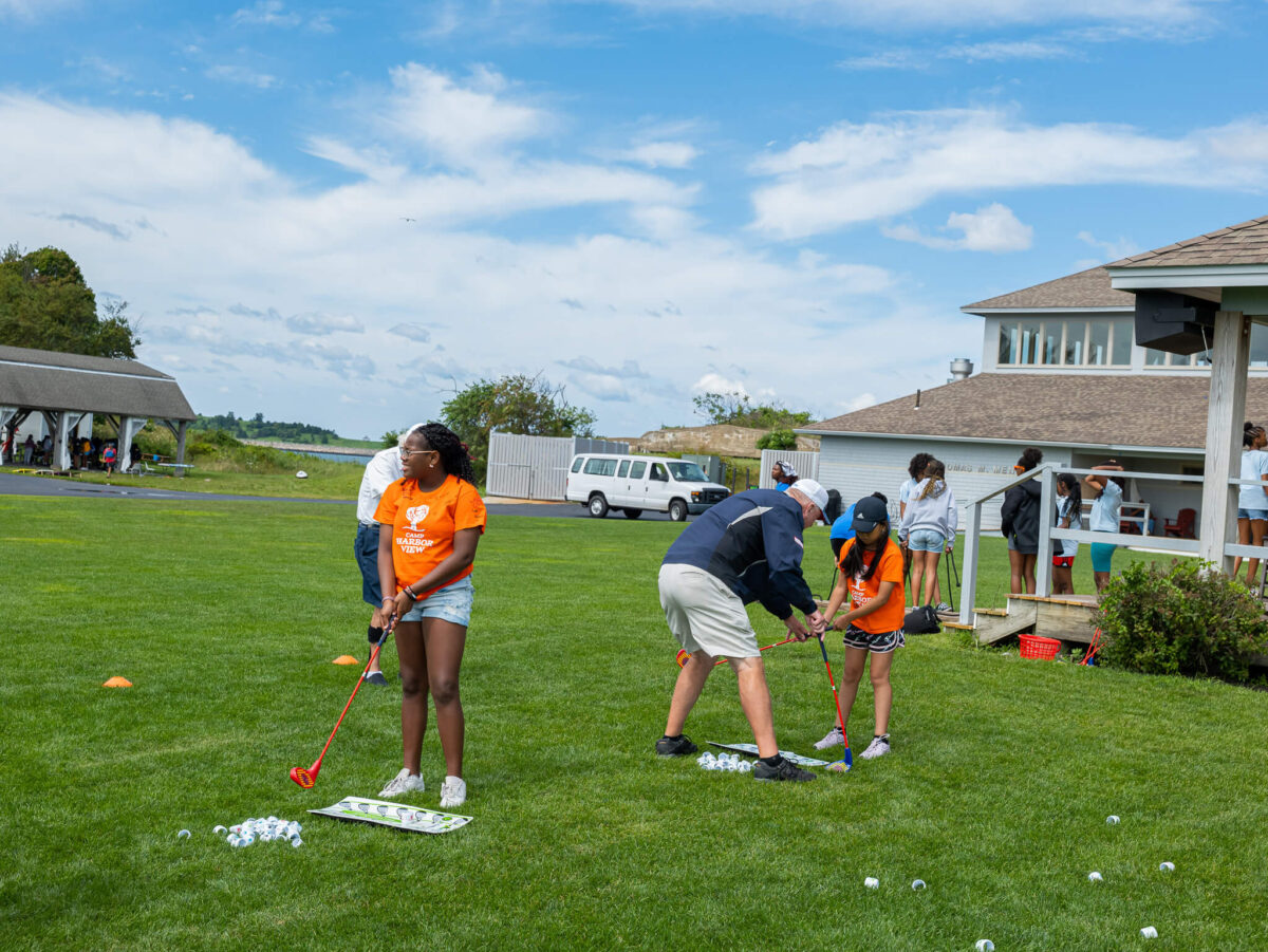 Campers learning how to golf