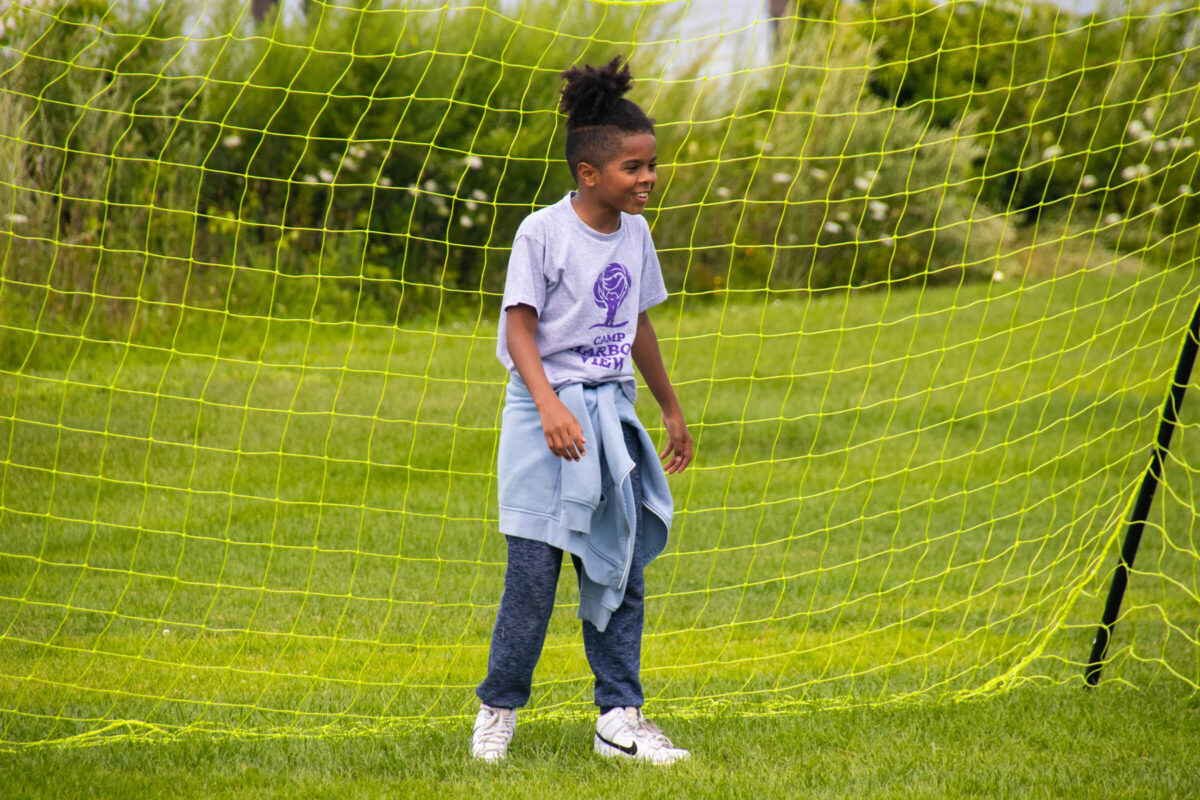 Camper playing soccer