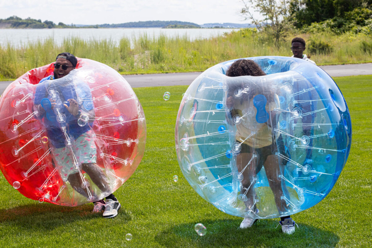 Camper and staff playing bubble soccer