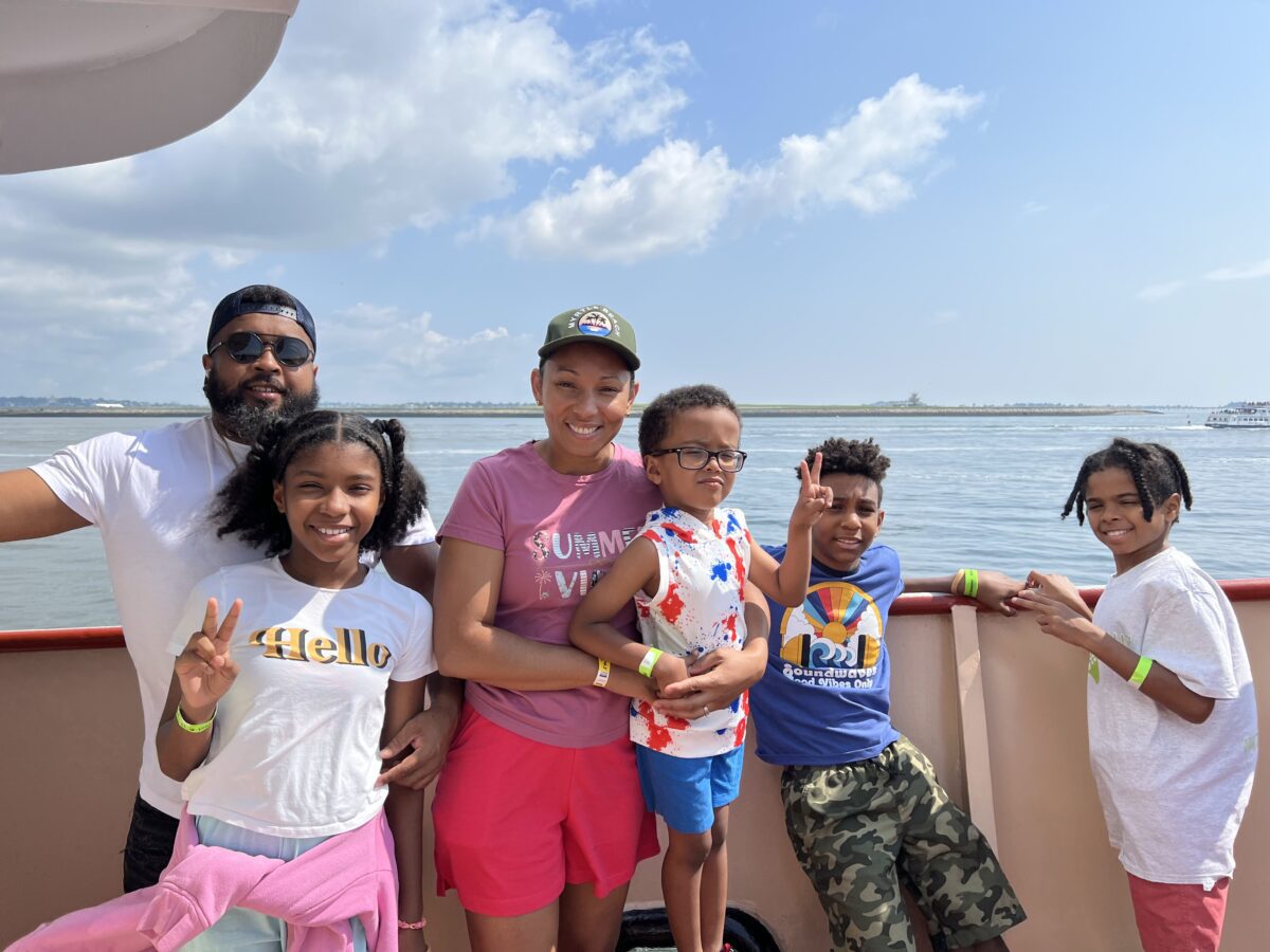 Family smiling together on the ferry during Family Day