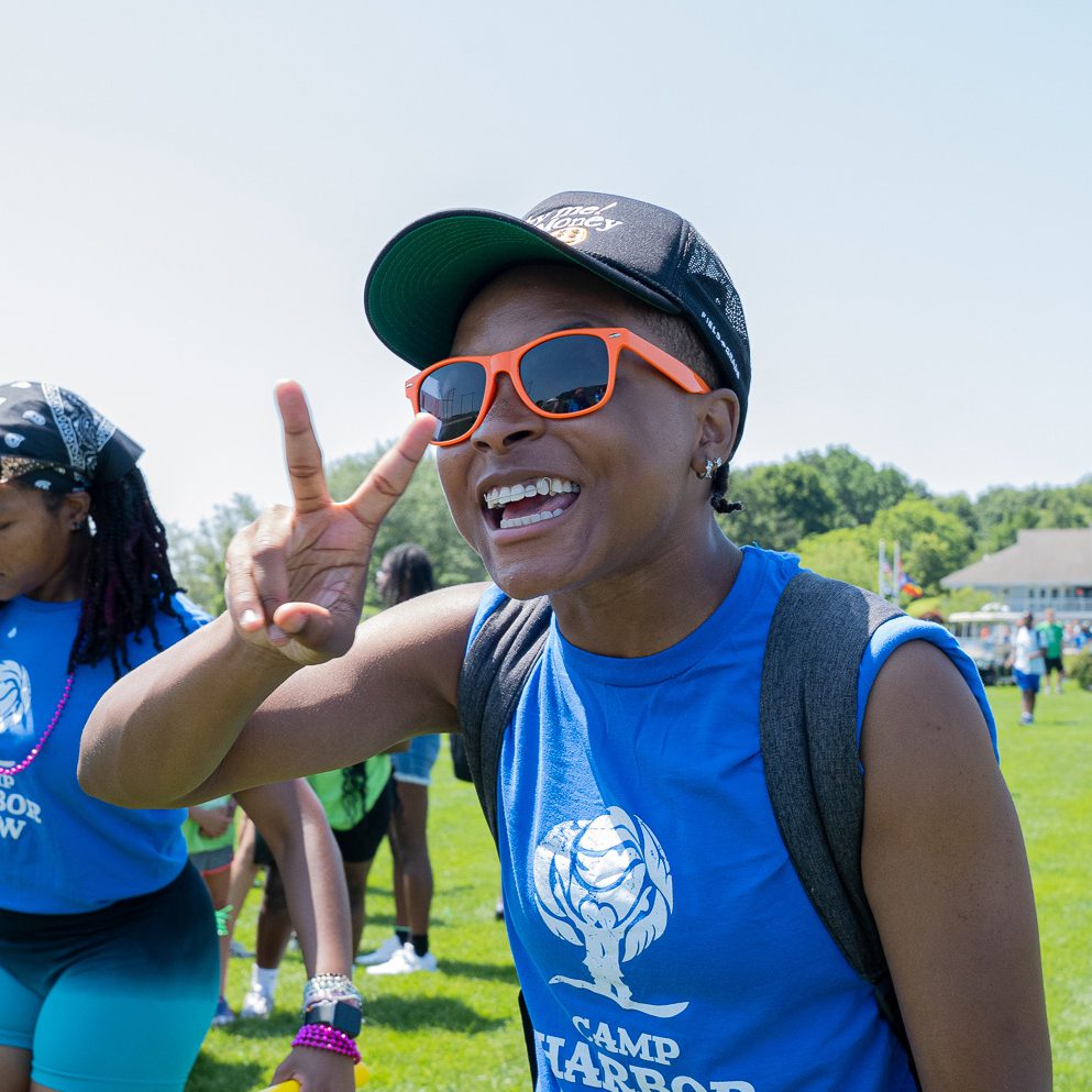 summer camp staff with sunglasses showing peace sign