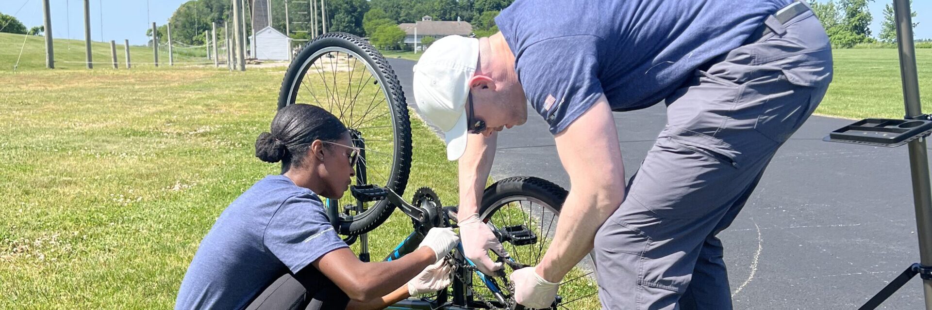 Two volunteers fixing a bike