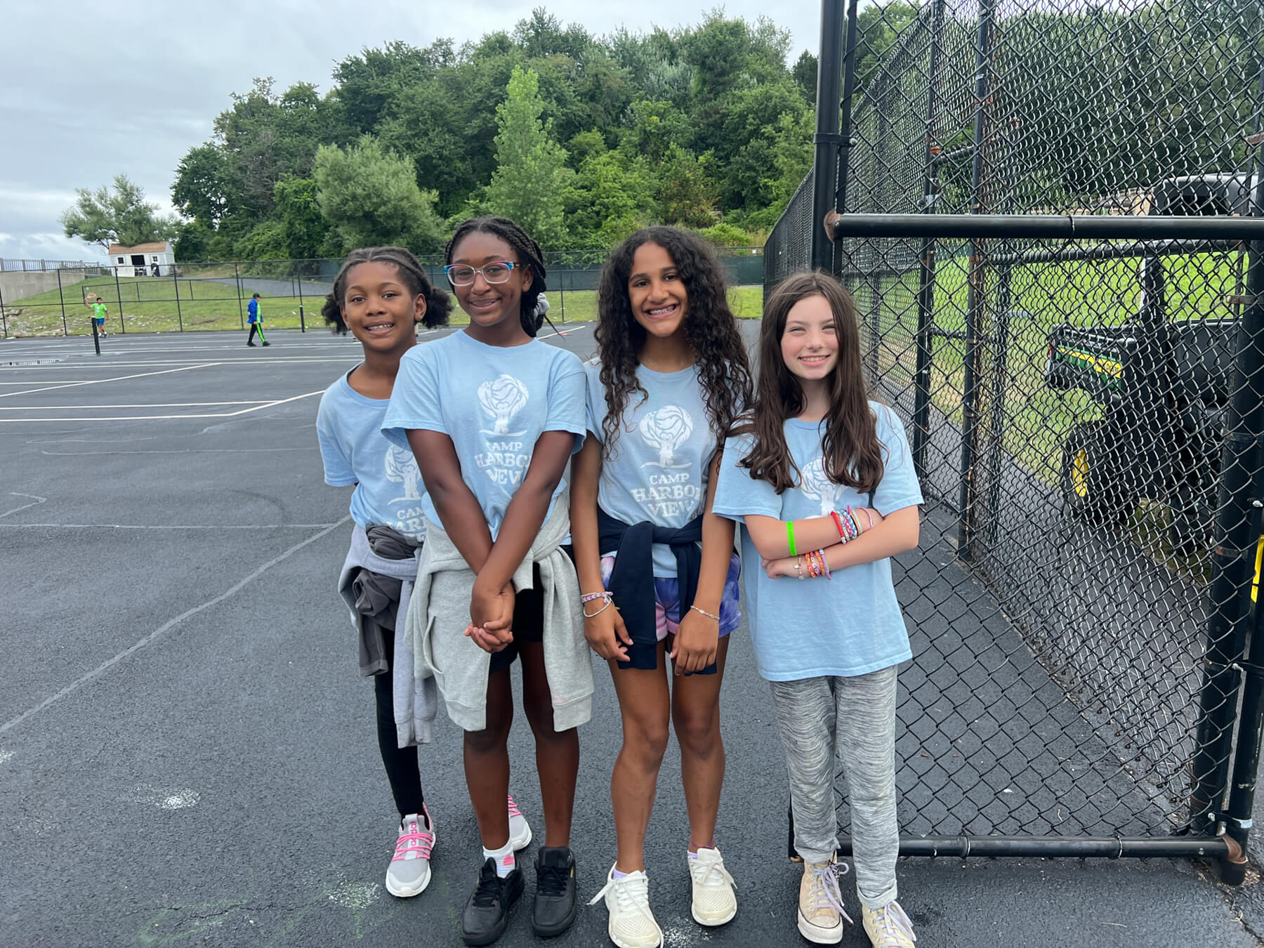 4 teens standing and smiling